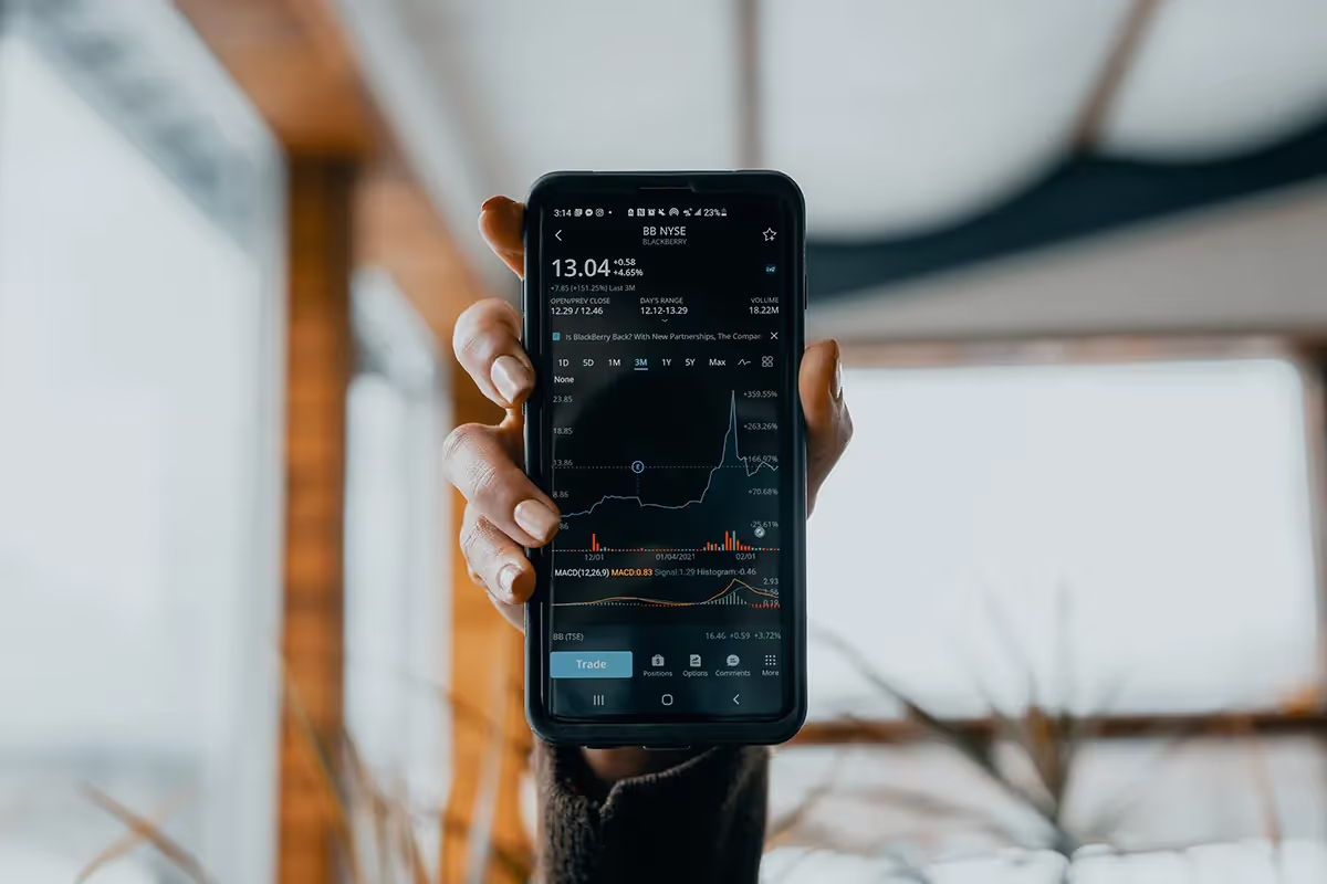 a phone showing stocks and graphs